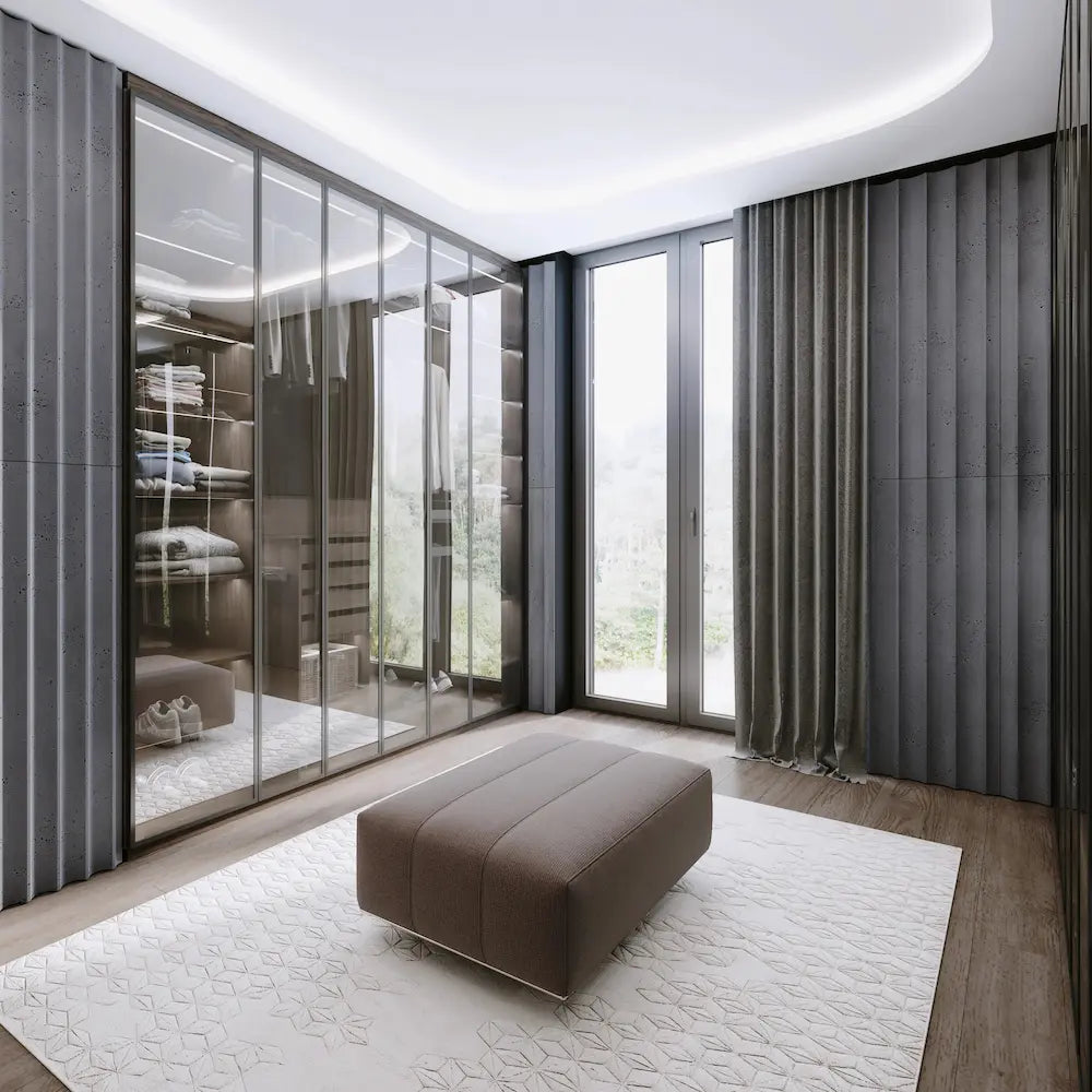 Modern interior with a brown ottoman on a white rug, large glass doors, and dark curtains.