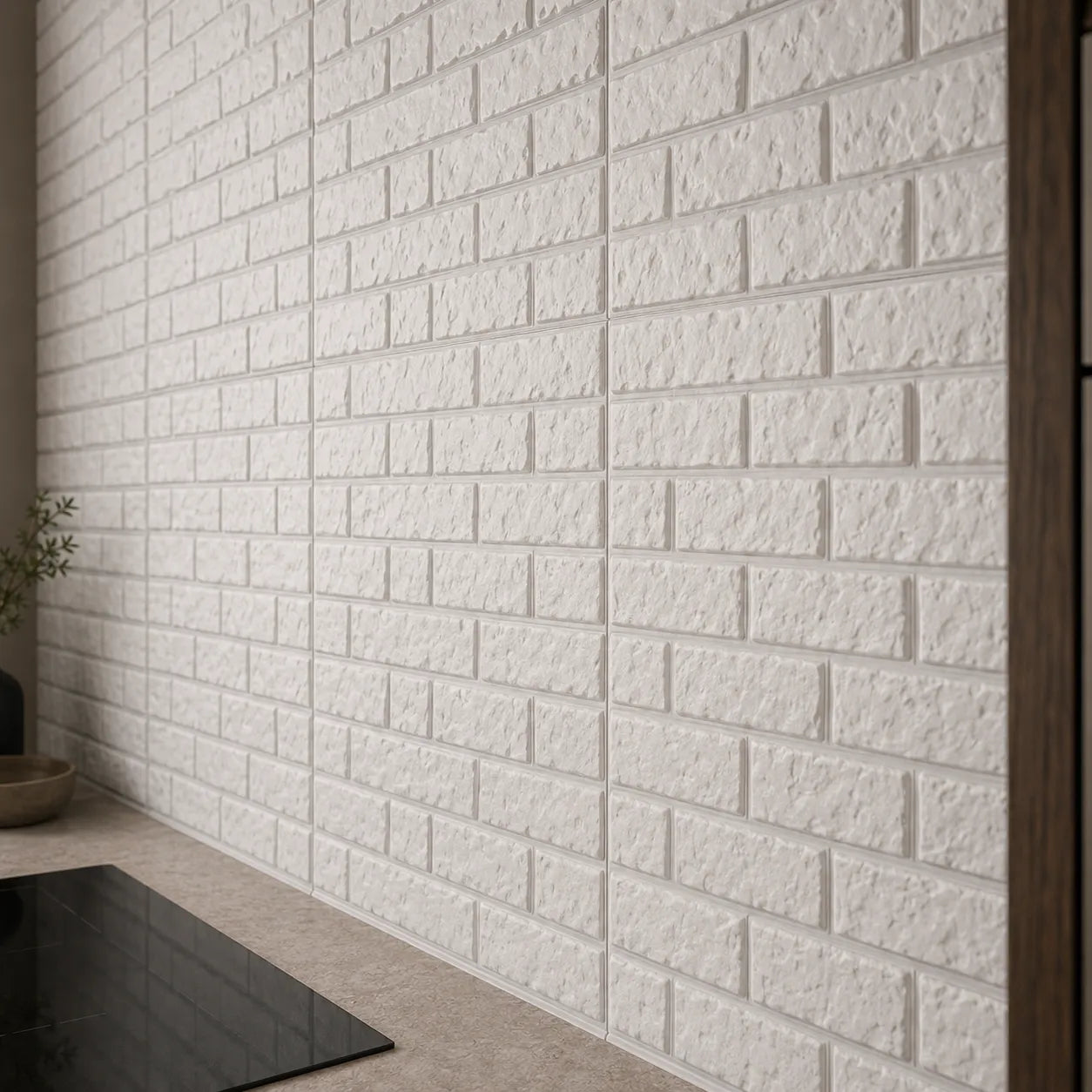 Close-up of textured white 3D brick-effect polystyrene wall panels above a modern kitchen worktop