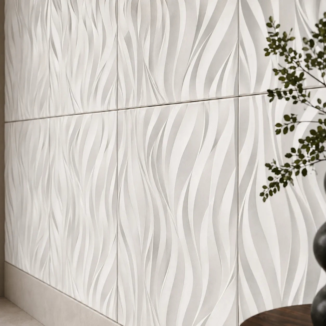 Close-up of white 3D polystyrene wall panels with a sculpted flowing flame pattern
