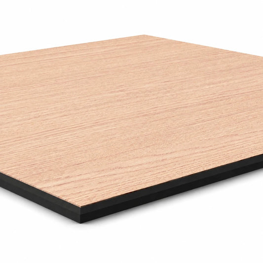 Close-up angled view of a smooth raw oak-effect MDF wall panel showing the wood grain and black core