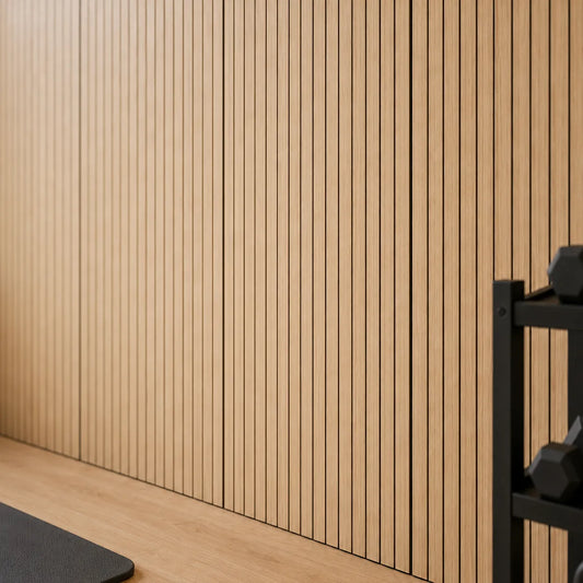 Close-up of oak veneer MDF acoustic wall panels with vertical black grooves in a modern fitness studio
