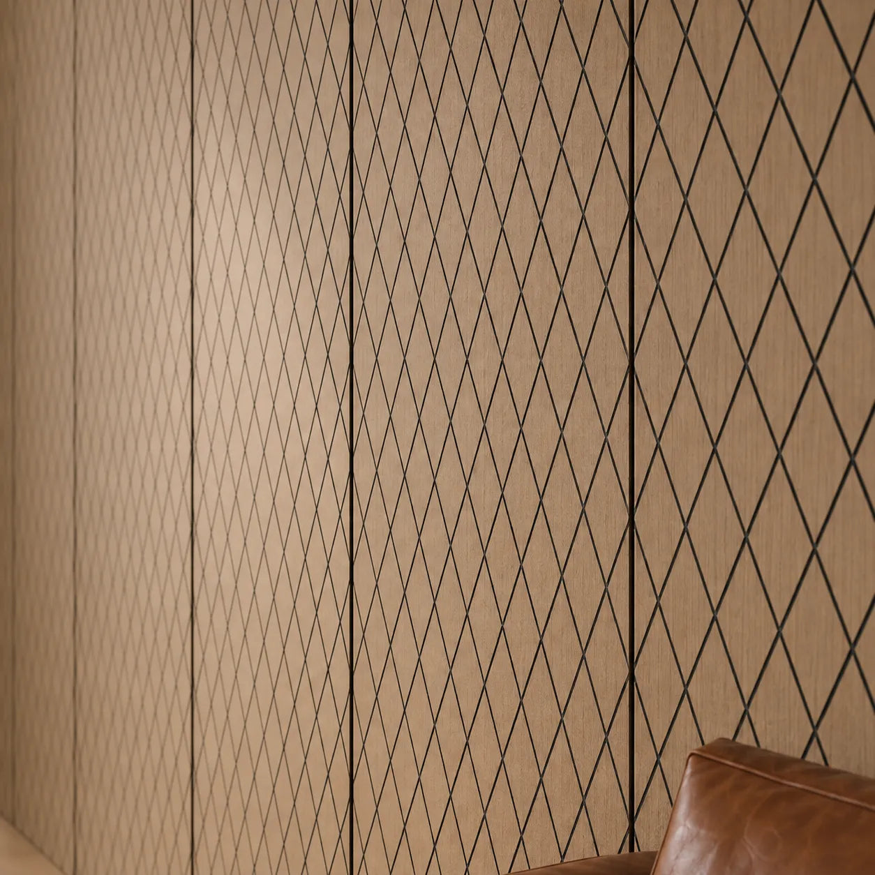 Close-up of natural oak MDF wall panels with precise black diamond grooves, visible wood grain and a leather sofa at the edge
