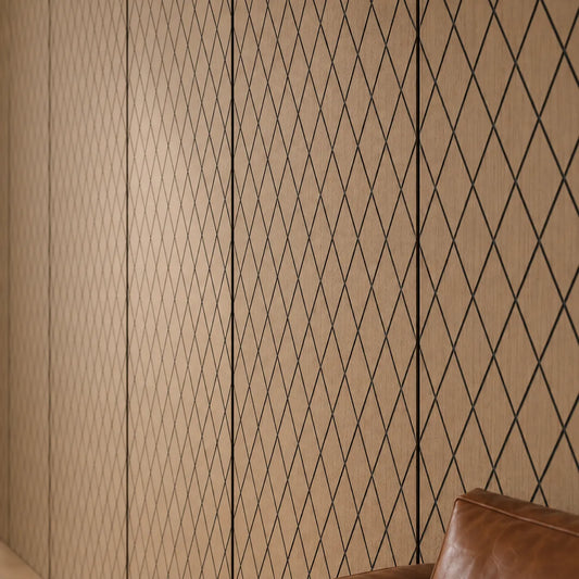 Close-up of natural oak MDF wall panels with precise black diamond grooves, visible wood grain and a leather sofa at the edge
