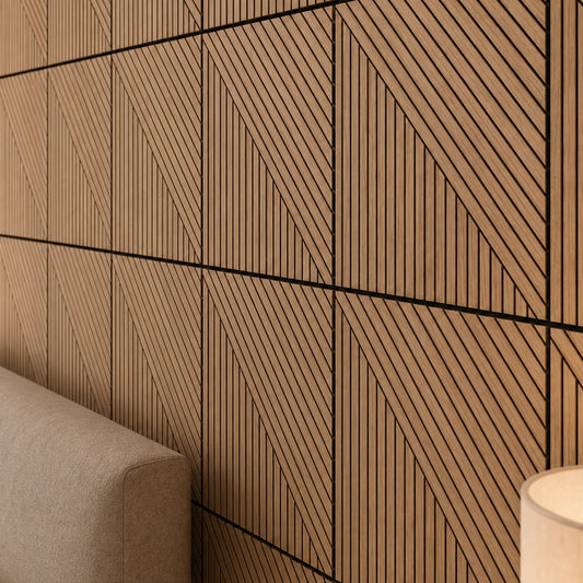 Close-up of geometric oak wall panels with vertical and diagonal grooves, black recessed lines and precise square joints