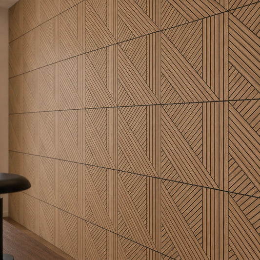 Close-up of GrooveCraft milled acoustic wall panels with oak veneer, black grooves and a geometric diagonal pattern