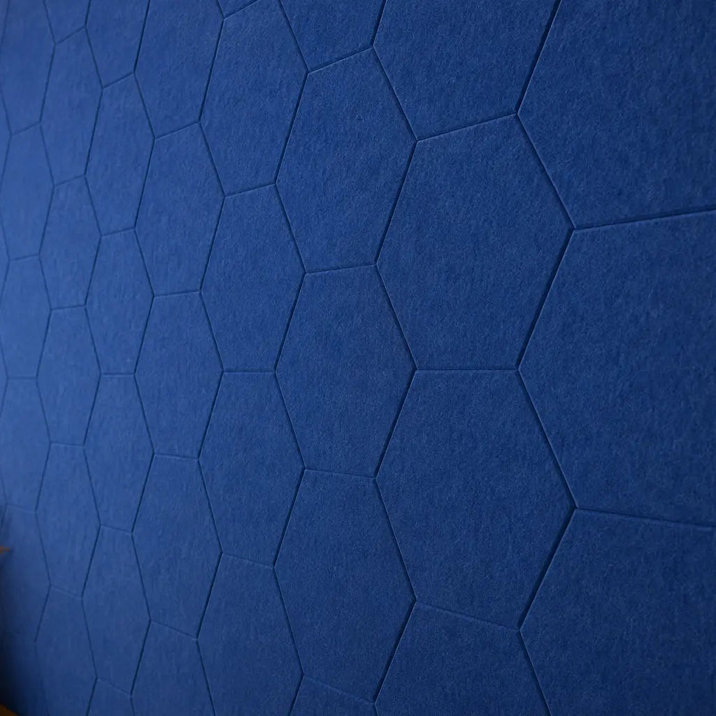 Dark blue HEXA 3D PET felt wall panel with a geometric hexagonal shape close up view
