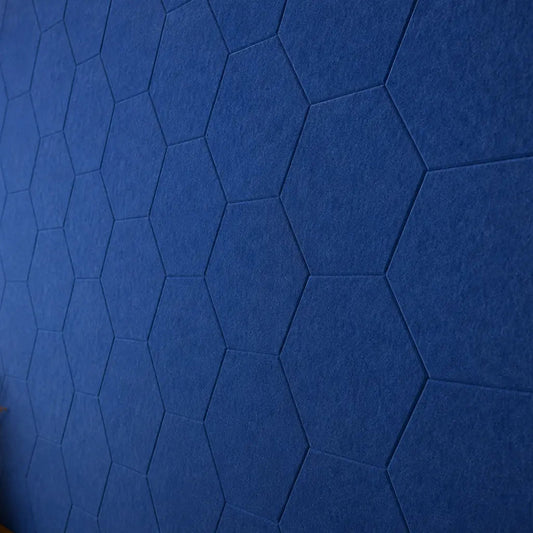 Dark blue HEXA 3D PET felt wall panel with a geometric hexagonal shape close up view
