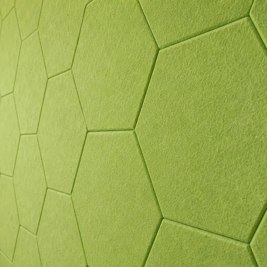 Green HEXA 3D felt PET wall panels in a cosy child’s bedroom with a wooden bed, study desk, storage unit and dog bed close up view