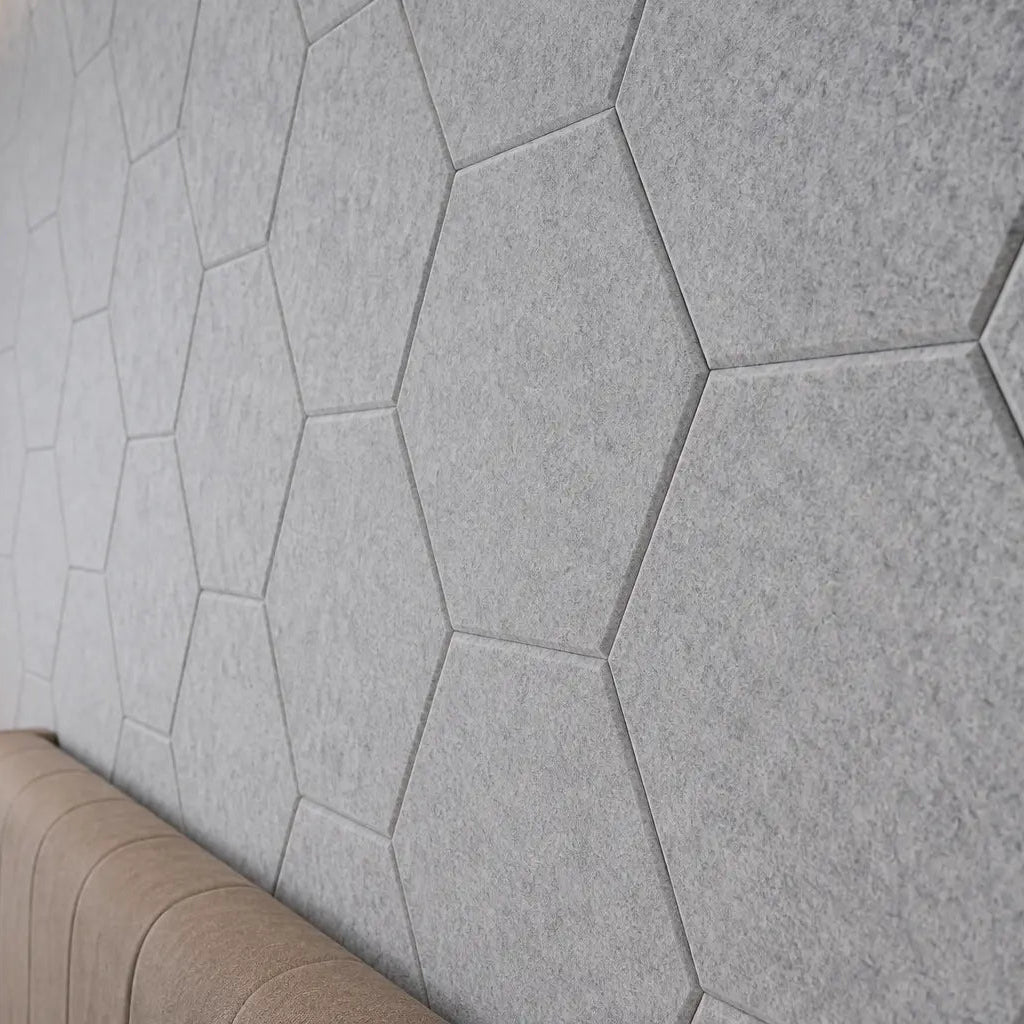 Close up view grey HEXA 3D felt PET wall panels in a contemporary bedroom