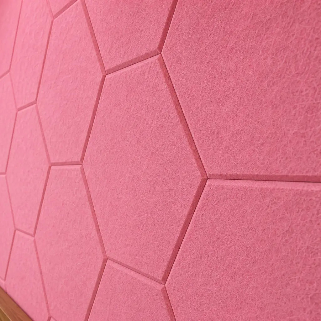 Pink HEXA 3D felt PET wall panels in a cosy child’s bedroom with a wooden bed, study desk, storage unit and dog bed close up view
