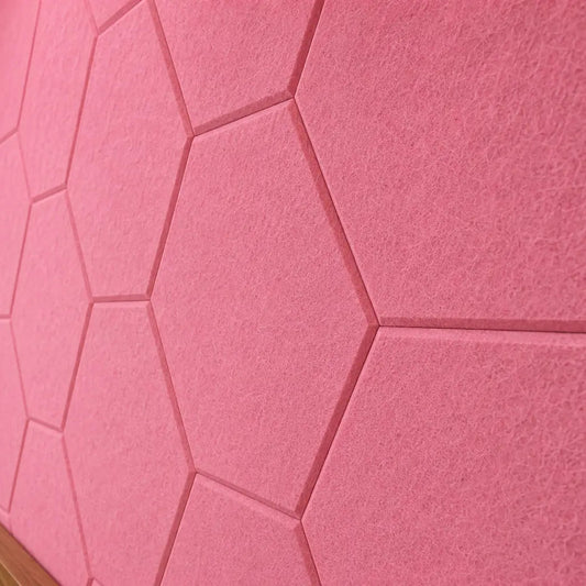 Pink HEXA 3D felt PET wall panels in a cosy child’s bedroom with a wooden bed, study desk, storage unit and dog bed close up view