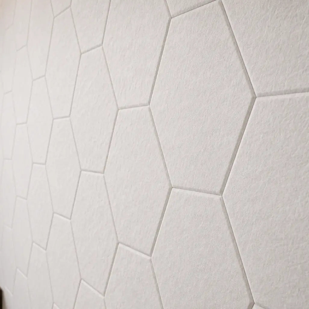White HEXA 3D felt PET wall panels in an elegant dining room with a dark wooden table, upholstered chairs and modern pendant lighting close up view
