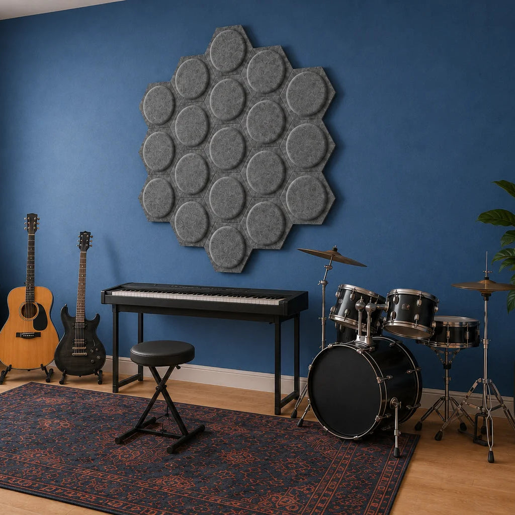 Angled view of grey hexagonal 3D acoustic panels in a music room with guitars, keyboard and drums