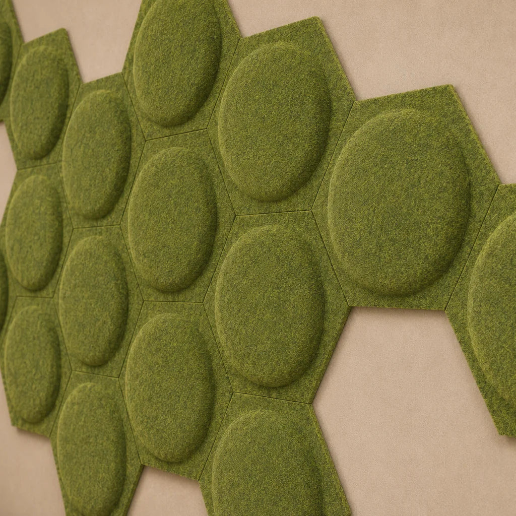 Close-up of olive hexagonal felt acoustic panels showing raised circular relief and a fibrous surface