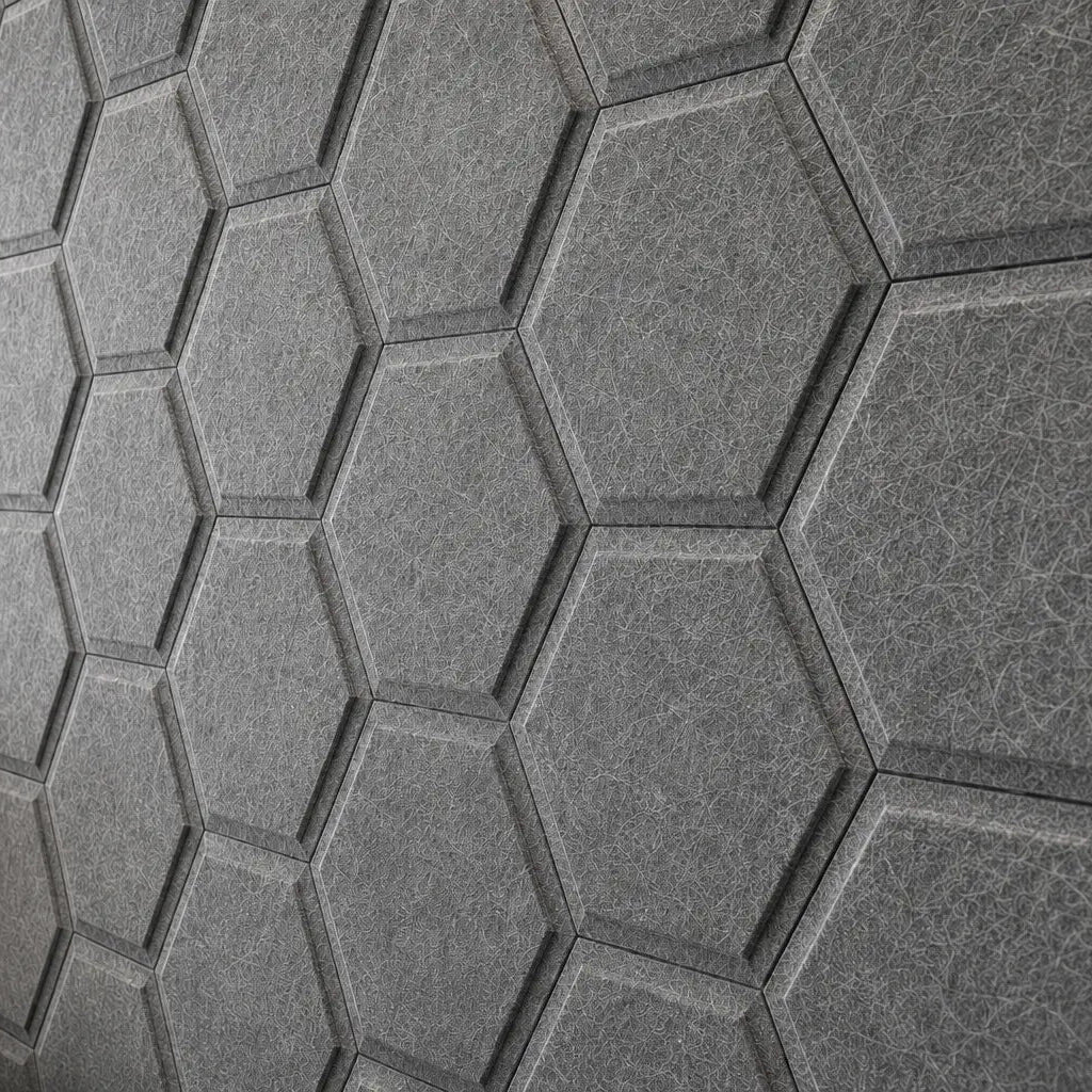 Close-up of grey HEXA BOLD 3D acoustic felt wall panels, highlighting their geometric relief, precise joints and fibrous surface texture