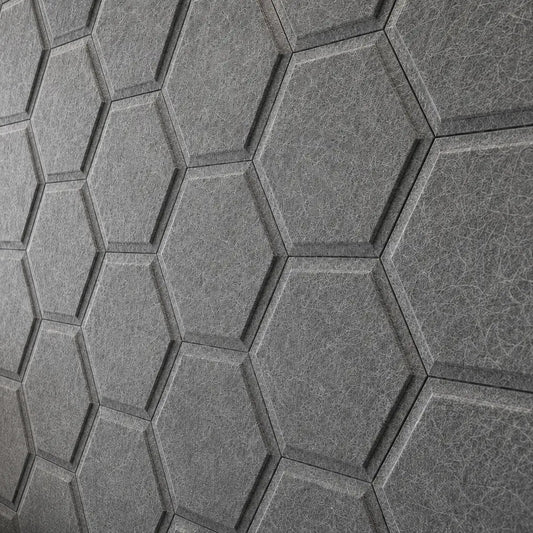 Close-up of grey HEXA BOLD 3D acoustic felt wall panels, highlighting their geometric relief, precise joints and fibrous surface texture