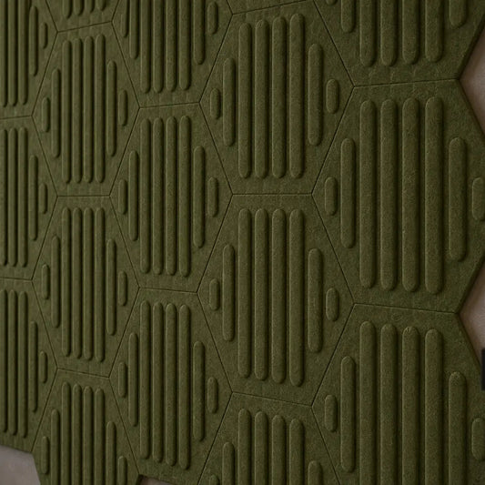 Close-up of olive HEXA RIFT 3D felt wall panels showing the raised pattern, precise joints and felt texture