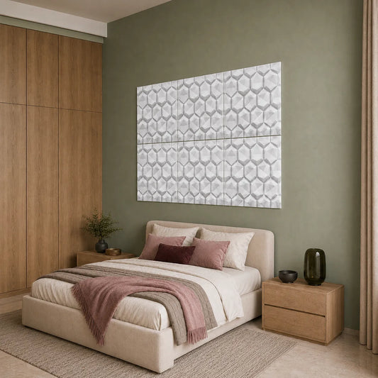 Angled view of white 3D hexagon polystyrene wall panels above a beige bed in a sage green bedroom