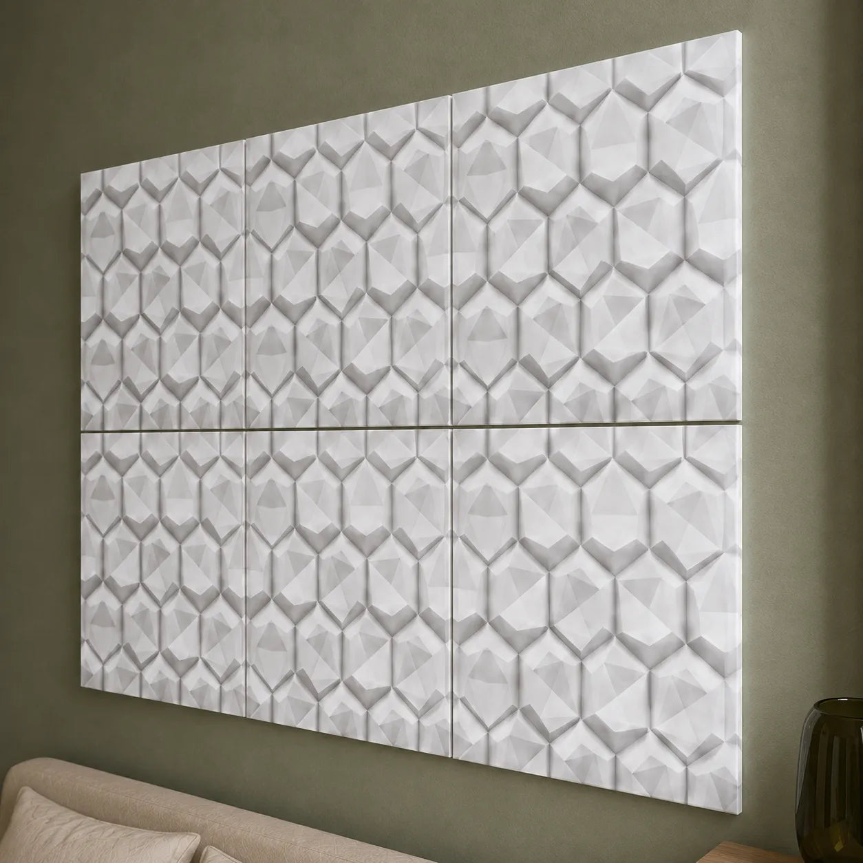 Close-up of white 3D polystyrene wall panels with a faceted geometric hexagon relief