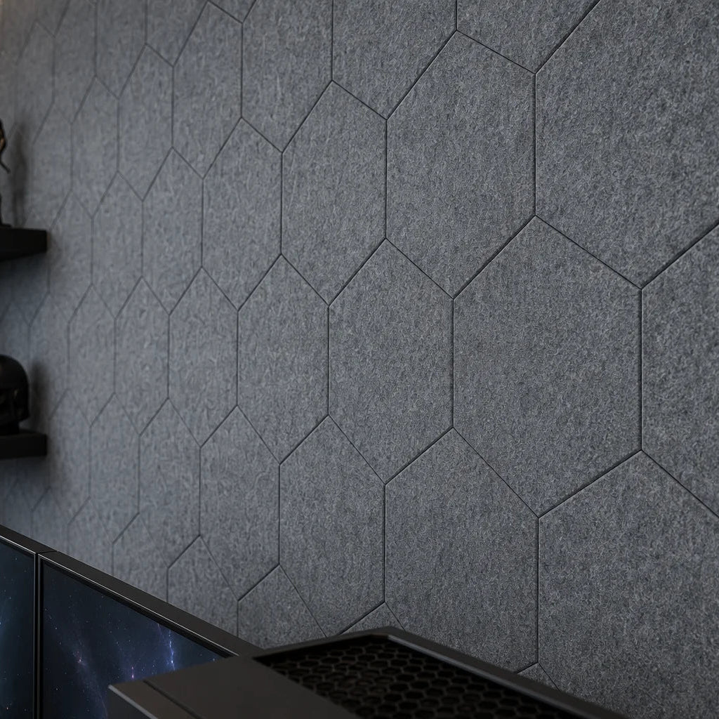 Close-up of grey flat hexagonal felt panels showing precise joints and a dense fibrous texture