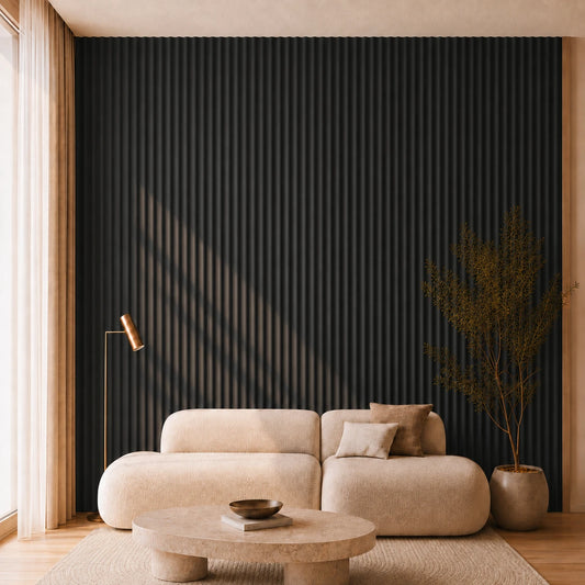 Modern living room with a cream curved sofa, round stone coffee table and floor-to-ceiling black concave fluted wall panels.