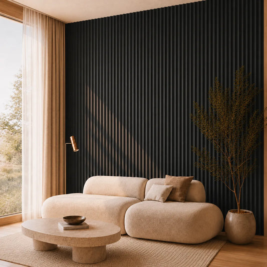 Angled view of a contemporary living room with black matt MDF concave fluted wall panels, a sculptural cream sofa and a stone coffee table