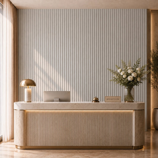 Elegant hotel reception with a marble desk, brass accessories, flowers and a cashmere-coloured fluted feature wall