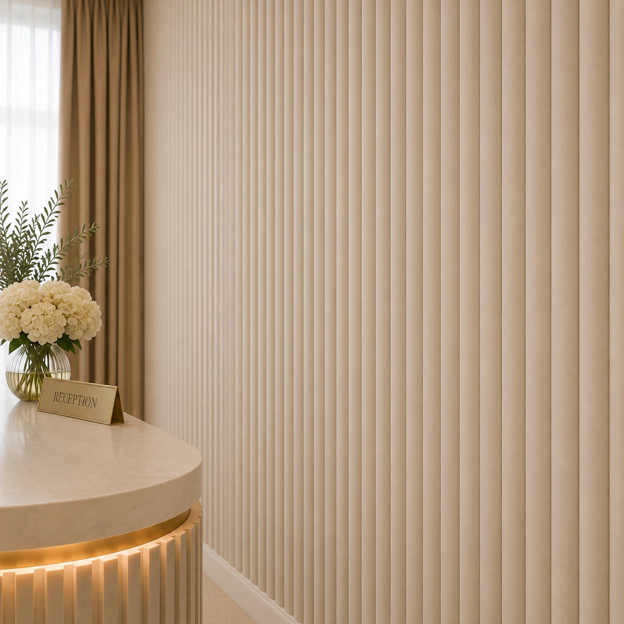 Close-up angled view of cashmere fluted wall panels, showing their narrow rounded relief and subtle texture, with part of the reception desk, a flower arrangement, and a gold reception sign