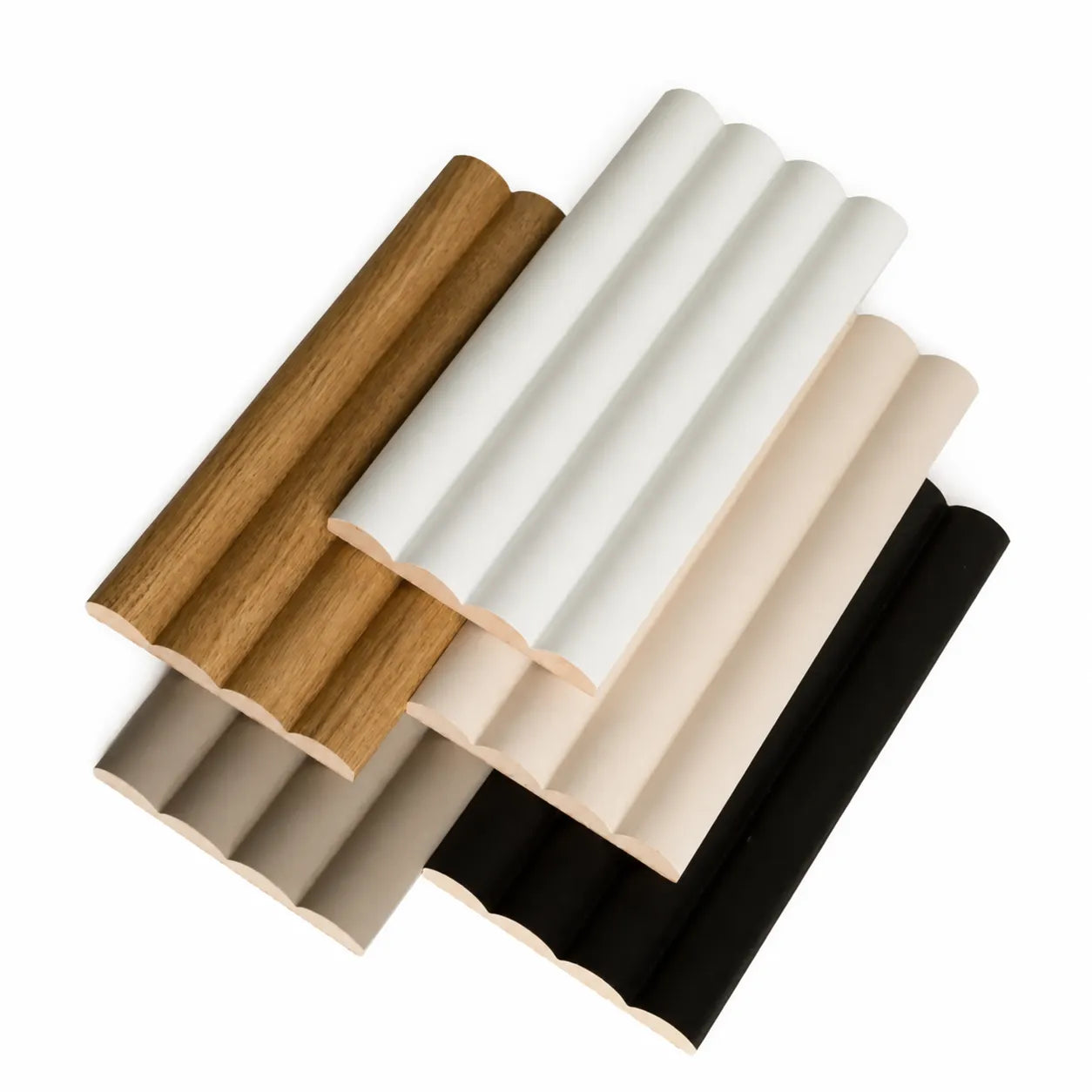 Stacked Montero fluted wall panel samples in white, oak, beige, taupe and black finishes
