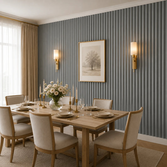 Angled view of an elegant dining room with a light wood table, cream upholstered chairs, floral centerpiece, brass accents, and a grey wall covered with narrow, rounded fluted panels
