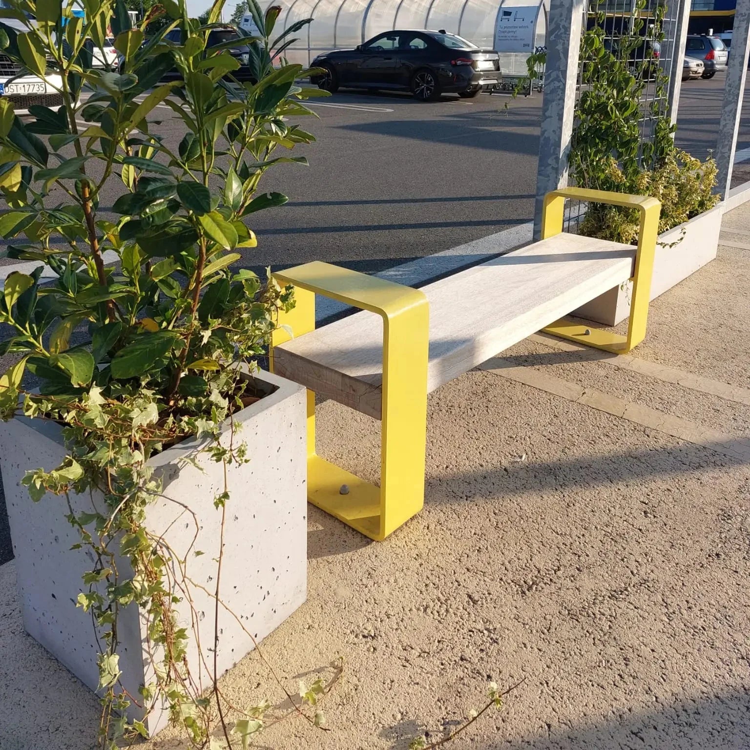 Outdoor Concrete Planters - Rectangle 50x120x50 cm in a parking lot next to a bench Decormania.eu