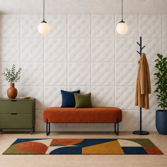 Front view of a stylish hallway with an orange bench, colorful geometric rug, coat stand, and white tufted-effect 3D polystyrene wall panels