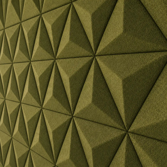 Olive PYRAMID 3D acoustic felt wall panels in a modern living room with a cream sectional sofa, wooden furniture and warm lighting close up