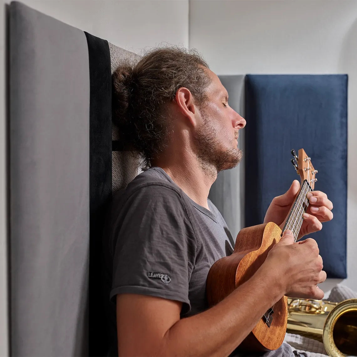 Padded Wall Panels Set 1 Grey in interior with a man playing instruments Decormania.eu