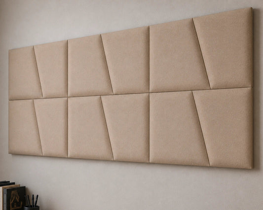 Close-up angled view of beige upholstered wall panels, highlighting the geometric seams, padded relief, precise joints and textured fabric finish