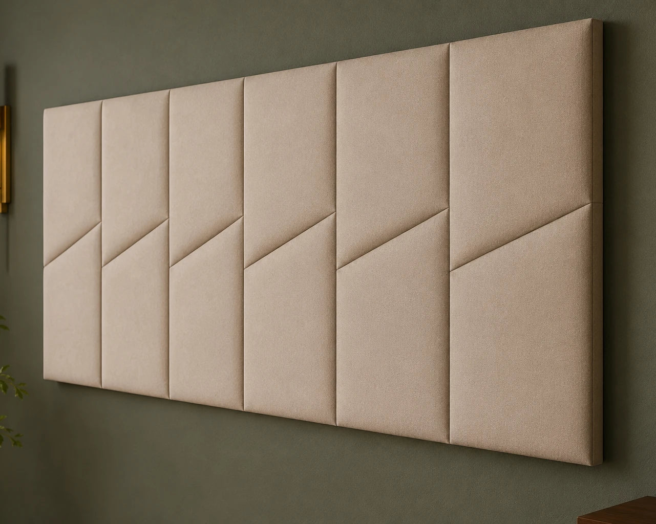 Close-up angled view of six beige padded wall panels, showing the fabric texture, diagonal seams and narrow joints