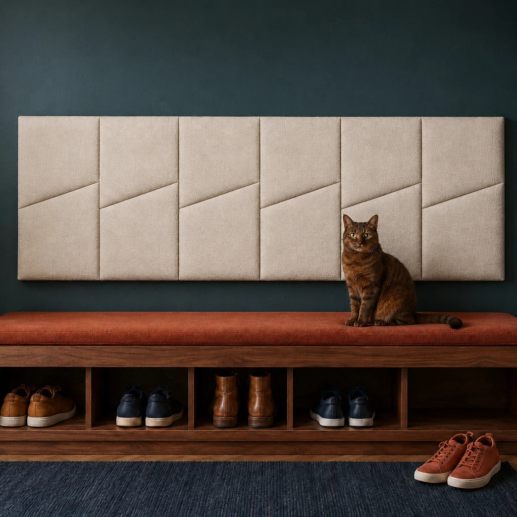 Front view of six cream padded wall panels with diagonal seams above an entryway bench on a dark teal wall