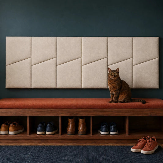 Front view of six cream padded wall panels with diagonal seams above an entryway bench on a dark teal wall