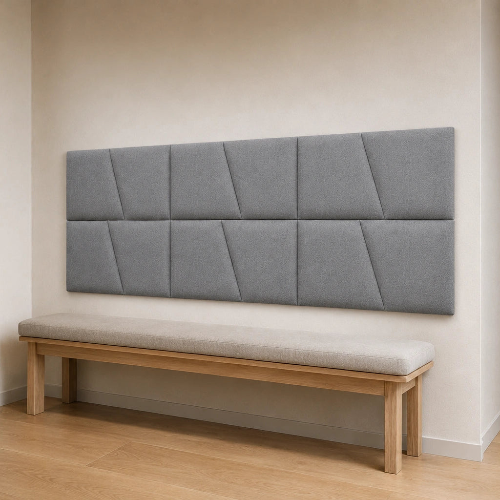 Angled view of a cream modular wall panel arranged in two rows above a sofa, showing its regular layout and geometric pattern