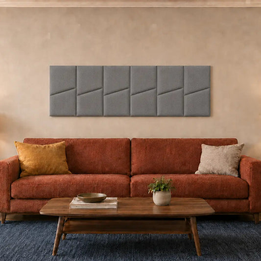 Front view of six grey upholstered wall panels arranged above a rust-coloured sofa in a warm modern living room