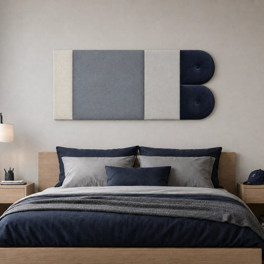 Front view of a geometric upholstered wall panel in cream, light grey and navy, displayed above a wooden bed in a modern bedroom