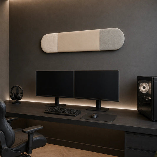 Angled view of a three-section beige, cream and light grey upholstered wall panel displayed above a dual-monitor gaming setup