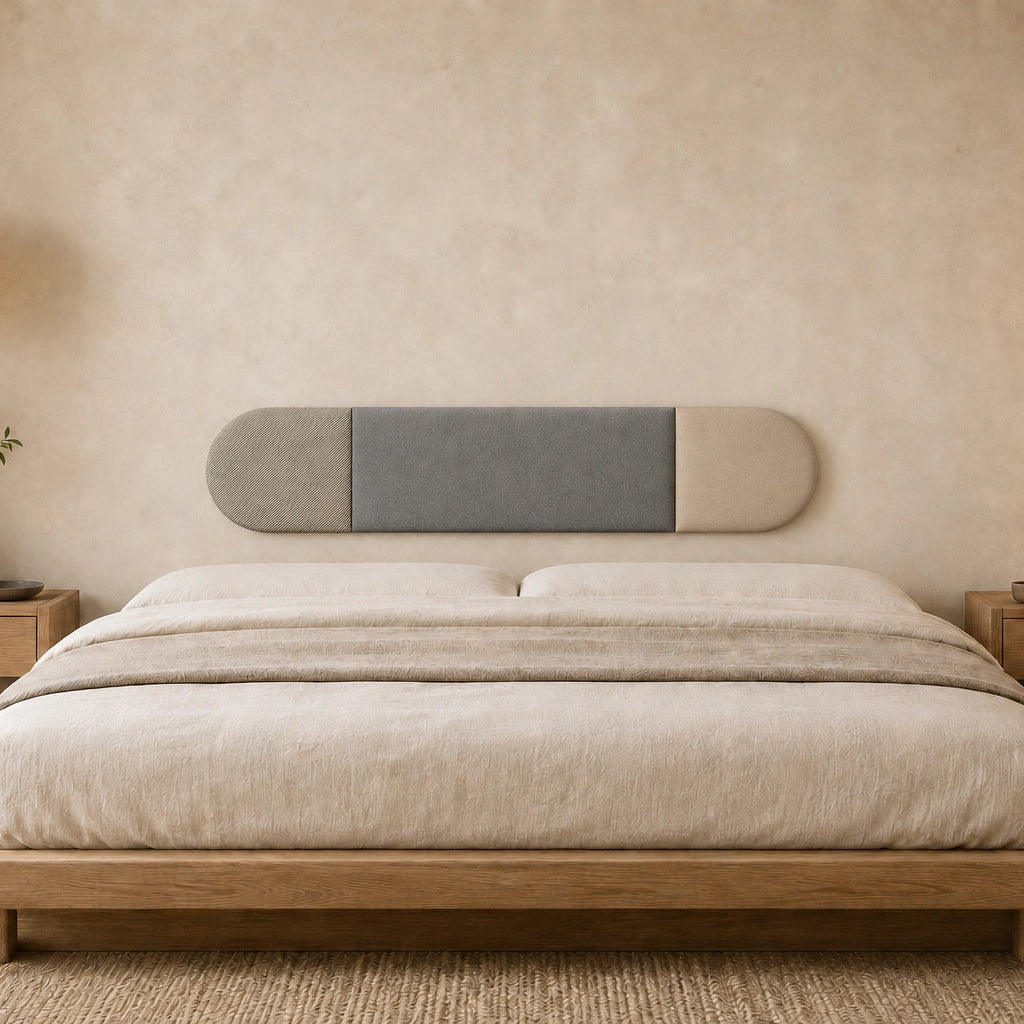 Front view of a three-section grey and beige upholstered wall panel displayed above a wooden bed in a warm, minimalist bedroom