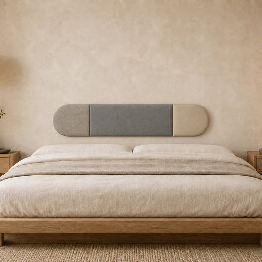 Front view of a three-section grey and beige upholstered wall panel displayed above a wooden bed in a warm, minimalist bedroom