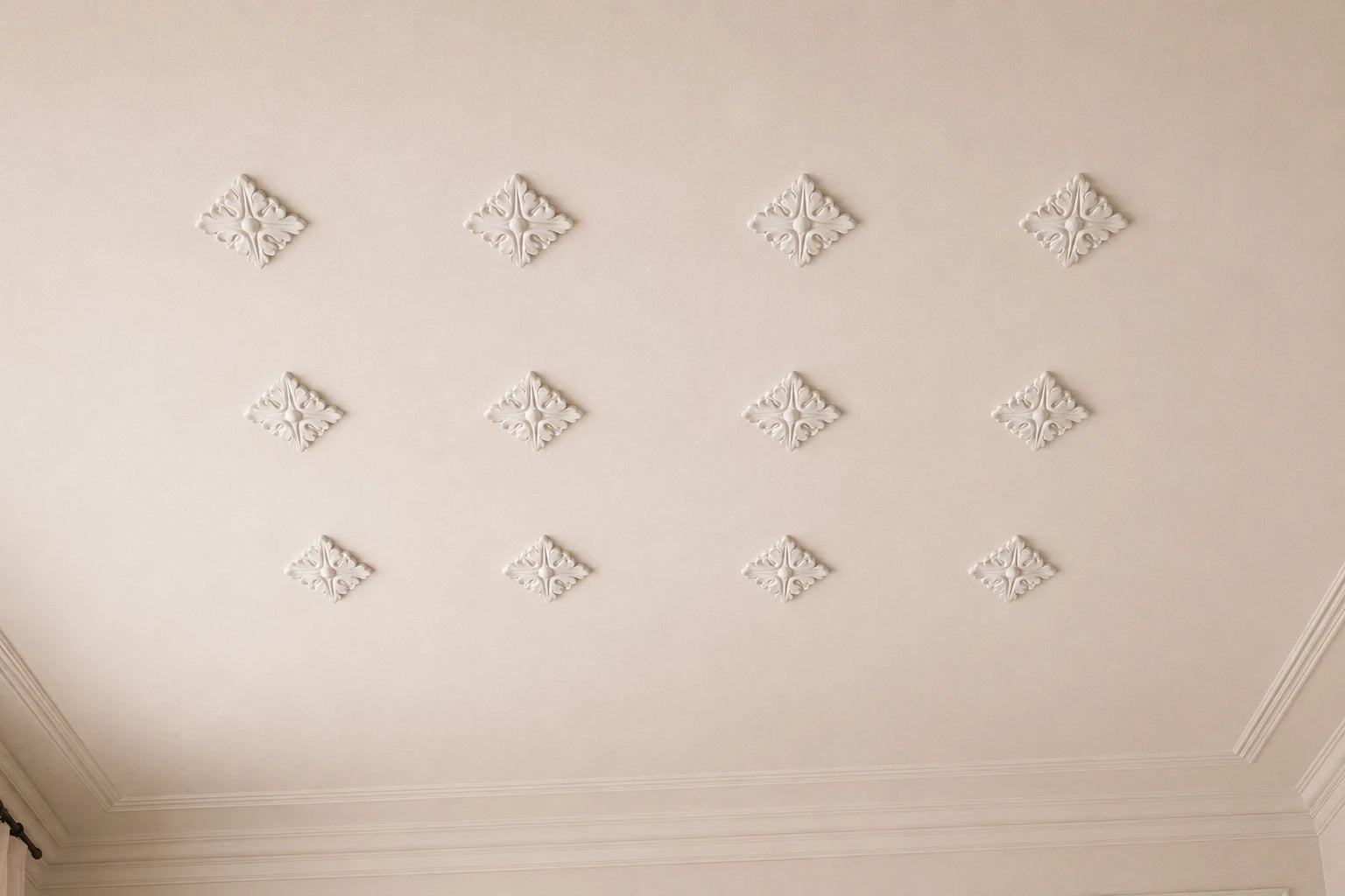 Close-up of twelve white R13 Arstyl diamond-shaped ceiling ornaments arranged in a regular grid