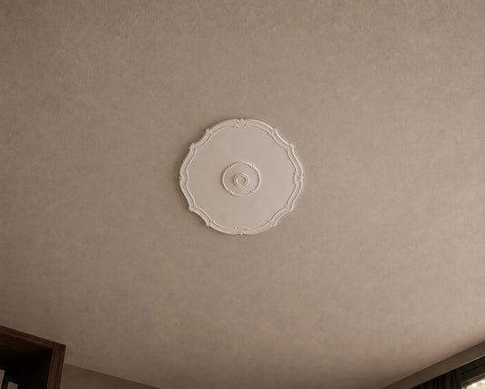 Close-up of the white R16 Arstyl ceiling rose with a smooth centre, delicate curved border and subtle ornamental details