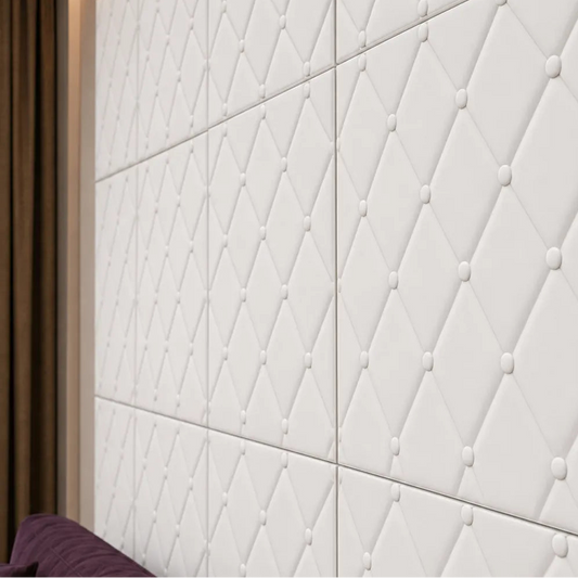 Close-up of white 3D polystyrene wall panels with a soft-button diamond relief pattern
