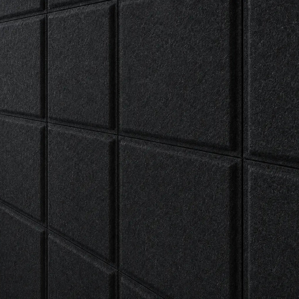 Close-up of black Square Bold 3D acoustic felt panels highlighting their fibrous texture and geometric relief