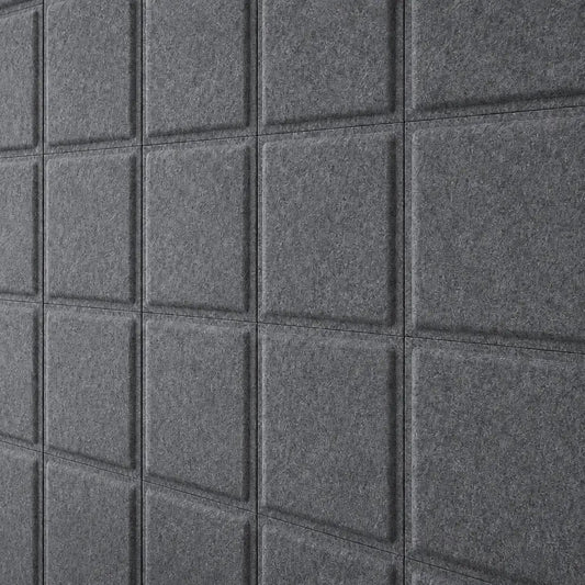 Close-up of grey Square Bold acoustic felt panels showing their textured surface and raised square design