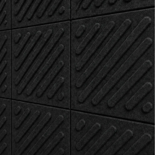 Close-up of black acoustic felt wall panels highlighting the fibrous texture, raised relief and module connections